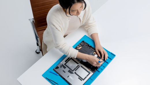 A top down view of a technician repairing a Surface device
