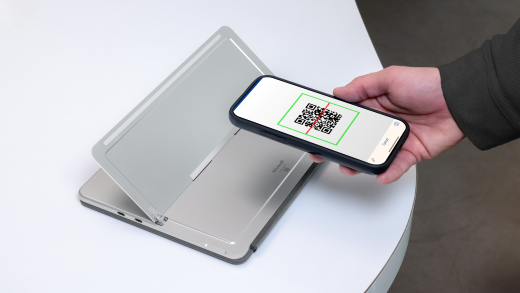 A person scanning the SN QR code on the back of the device